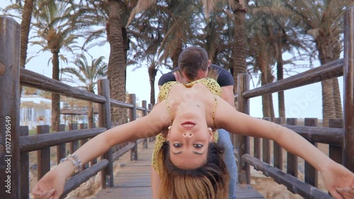 Couple Dancing Latin Dance on a Wooden Bridge with Palm Trees in the Background. Pareja Bailando Baile Latino en un Puente de Madera con Palmeras de Fondo