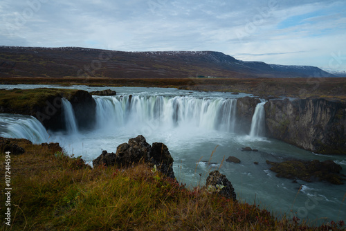 Long waterfall with a rough cliff