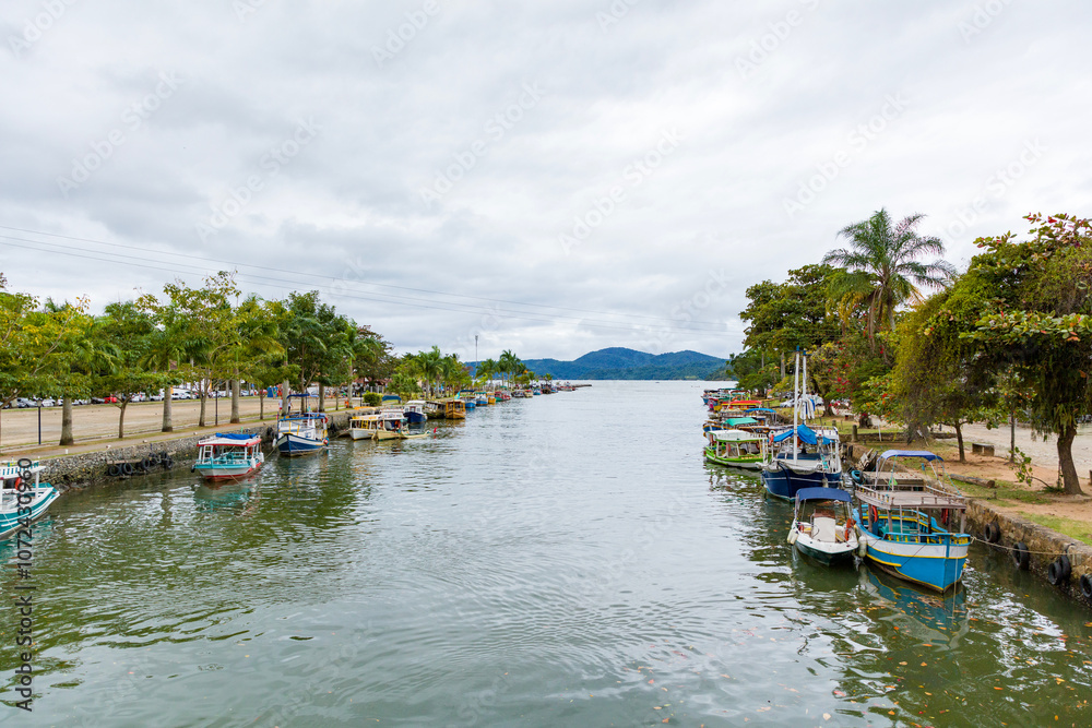 Boat dock at Paraty Bay in Rio de Janeiro, Brazil, where passenger boats await tourists to be taken to nearby islands or other villages. Boat dock at Paraty Bay in Rio de Janeiro, Brazil, where passenger boats await tourists to be taken to nearby islands or other villages.