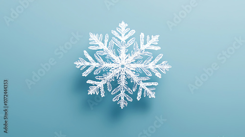 Close-Up of Intricate Snowflake on Minimalist Blue Background