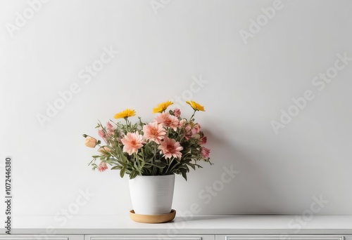 A mockup of a wall with a pot of flowers on a white surface