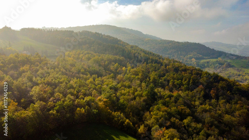 Vista aerea dei coloratissimi boschi e prati dell'Appennino modenese durante una soleggiata giornata d'autunno photo