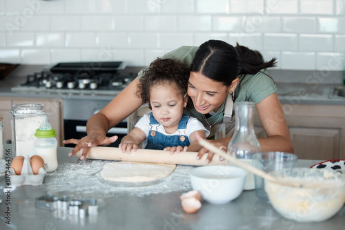 Happy mother, kid and learning baking with rolling pin for dough, flour and toddler in kitchen. Mom, child and cooking with parent, help and teaching girl dessert recipe for support in family home