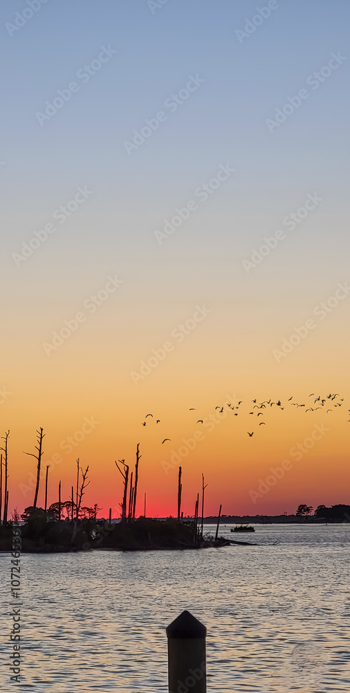 October Orange Sunset over a barrier island by the Intracoastal Waterway in Perdido Key, Florida October Orange Sunset over a barrier island by the Intracoastal Waterway in Perdido Key, Florida