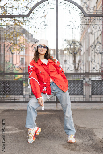 Happy beautiful woman walking and dancing outdoor. Young carefree girl enjoys the day and dancing