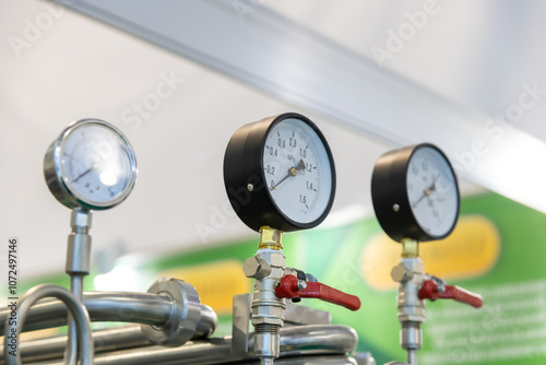 Close-up view of group of pressure gauges of milk pasteurization and cooling machine turned off. Industrial background. Soft focus. Copy space. Food and drink processing equipment theme.