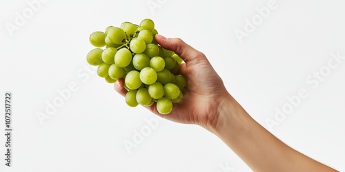 A fresh hand holding a bunch of green grapes on a simple background. The vibrant color draws attention. Great for health and wellness themes. Perfect for food and lifestyle imagery. AI