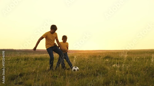 Wallpaper Mural happy family sunset. group people playing soccer with soccer ball. boys play football with their father. child kid run around field kick ball with their foot. children play green field with brothers Torontodigital.ca