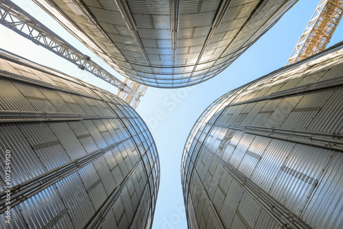 Silo Grain bins view from bottom to top. Grain dryer complex. Granary with loading tower. photo