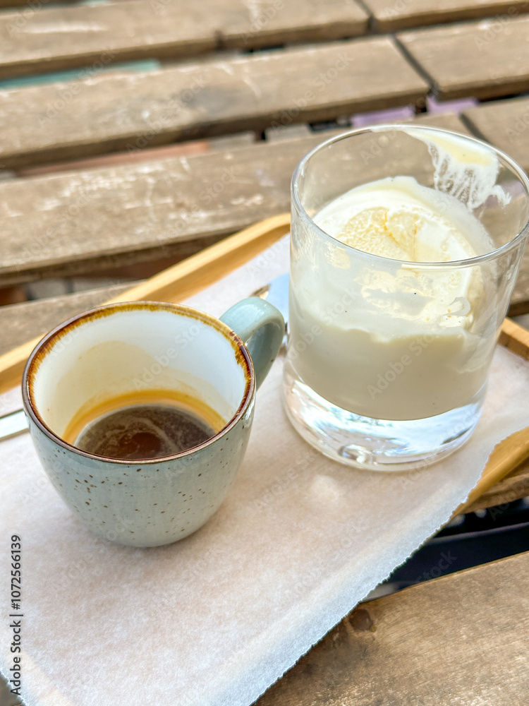 Cup of espresso with a glass of creamy affogato on a wooden table Cup of espresso with a glass of creamy affogato on a wooden table