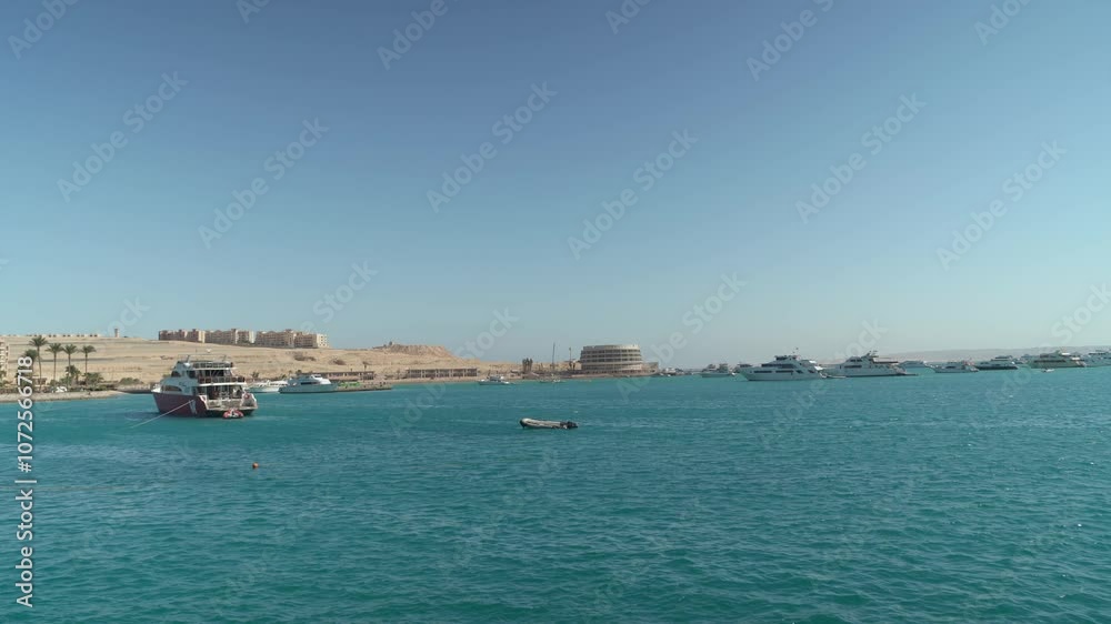 Yachts on the shores of the Red Sea in Hurghada, Egypt against the background of the desert. Yachts on the shores of the Red Sea in Hurghada, Egypt against the background of the desert.