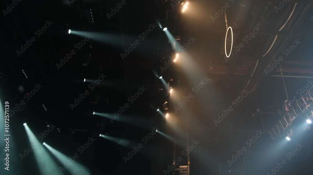 The ceiling of the film studio with many lighting fixtures installed on the farm at the theater or concert hall. Professional lighting equipment. Ring or hoop for gymnastic exercises