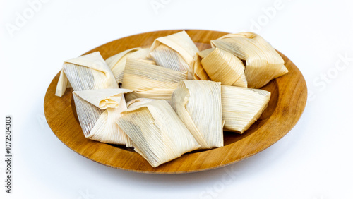 Wajik kletik is a cake originating from Blitar. Wajik kletik is made from sticky rice, coconut milk, and brown sugar. This food is wrapped using corn husks or klobot. photo