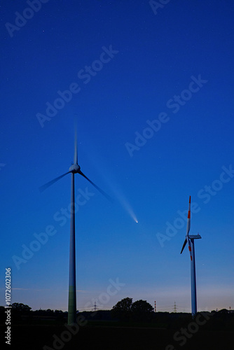 Comet C/2023 A3 Tsuchinshan-ATLAS in the night sky between two wind turbines