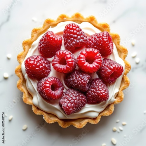 Top view of tasty sweet tart with cream and fresh raspberry isolated on white background