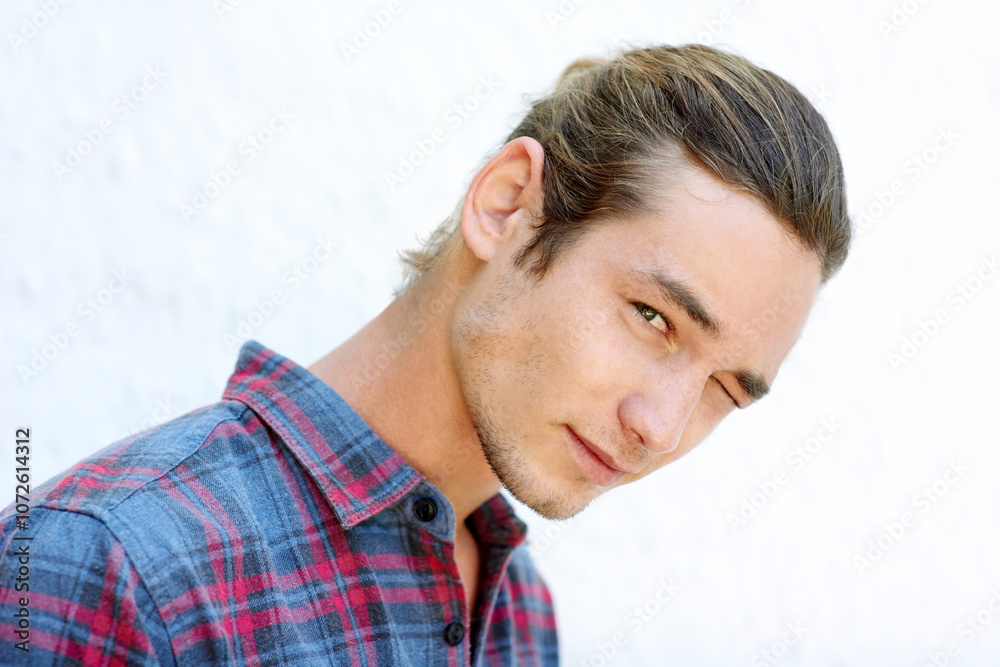 Obraz premium Wall, man and portrait with wink for fashion, stylish shirt and cool with expression for confidence. Male person, student and edgy with flirting for checkered clothes, hipster and trendy for summer
