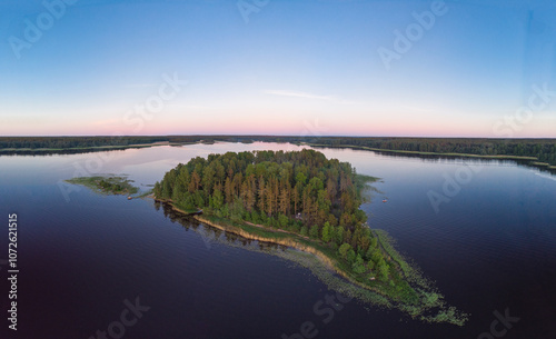 Aerial top view to island in summer evening during white nights. Vuoksa lake river and channels system leaking in Finland and Russia flowing into Ladoga. Romashki village, Leningrad region, karelia.