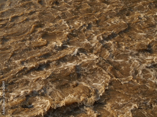 Photos Choppy, muddy, brown river water.