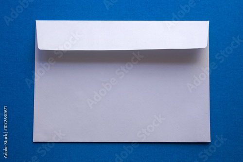 white envelope on blue background. top view