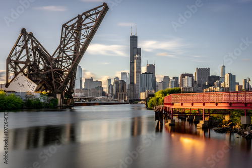View of Downton Chicago, Illinois with Chicago River and railroad bridge at dusk. 