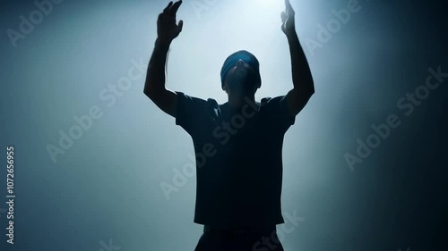 Blindfolded individual removing his blindfold in a smoky studio setting