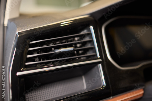 Closeup of car dashboard air vents near gear shift