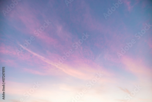 A beautiful sky tinted by the sun leaving vibrant shades of gold, pink, blue and multicolored. Clouds in the twilight evening and morning sky. Cloudy sky background in the evening, and during the day.