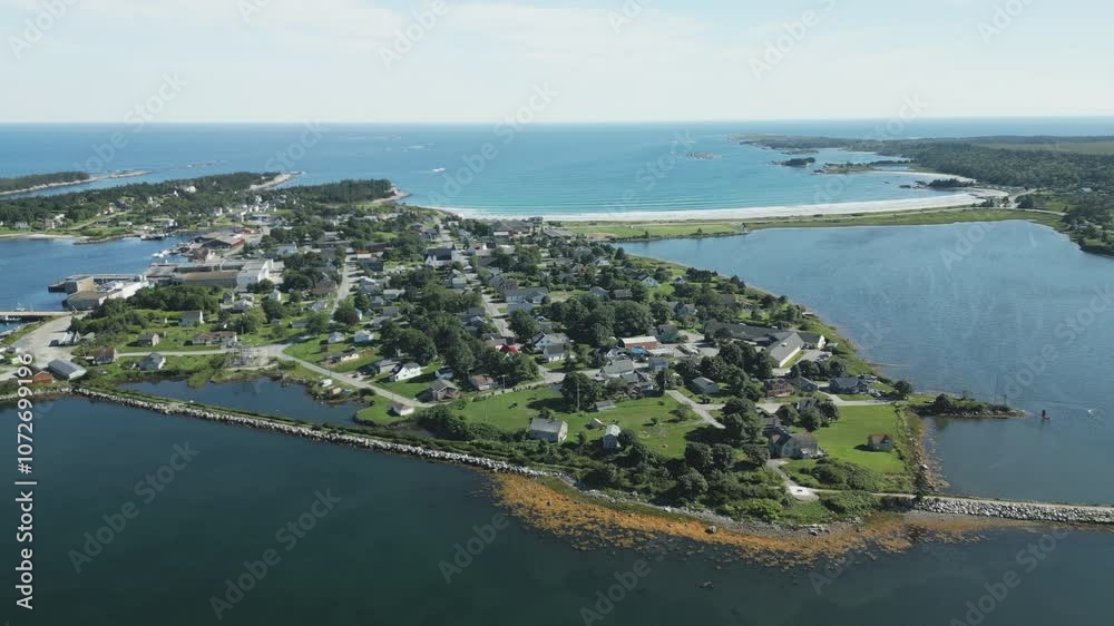 Aerial overview of the idyllic maritime village and harbour of Lockeport, Nova Scotia, Canada - home port to many a Lobsterman. MAX QUAL PRORES422HQ Transcode of 4K H.265 D-CINELIKE original capture. Aerial overview of the idyllic maritime village and harbour of Lockeport, Nova Scotia, Canada - home port to many a Lobsterman. MAX QUAL PRORES422HQ Transcode of 4K H.265 D-CINELIKE original capture.