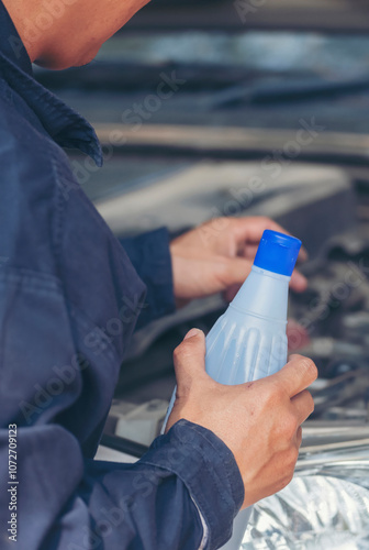 Vertical Mechanic man hands repairing car shop. Man hands fixing Car machinery vehicle mechanical service. Vertical horizon vehicle hood checking automobile. Car motor Workshop oil garage maintenance