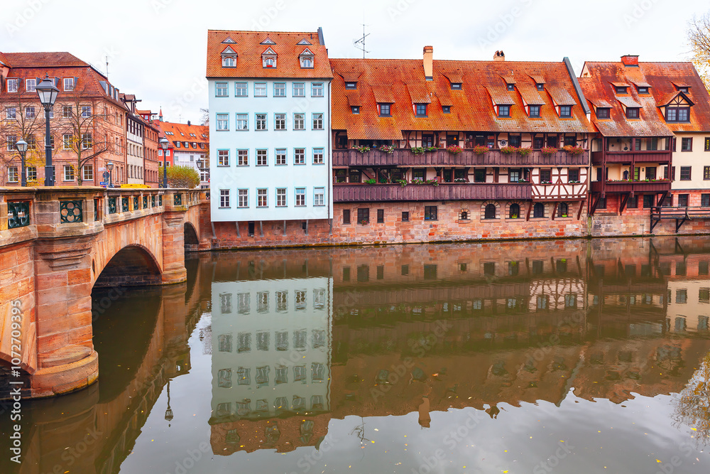 Maxbrucke bridge over Pegnitz river in Nuremberg. Scenic view of a bridge crossing a river, framed by residential coastal buildings