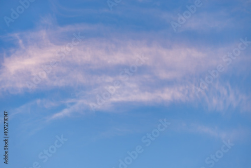 A beautiful sky tinted by the sun leaving vibrant shades of gold, pink, blue and multicolored. Clouds in the twilight evening and morning sky. Cloudy sky background in the evening, and during the day.