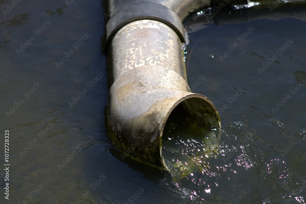 silver metal pipe shooting out water into pool silver metal pipe shooting out water into pool