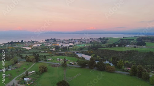 Aerial view of Llanquihue city with Osorno and Calbuco volcanoes and Llanquihue lake on sunset