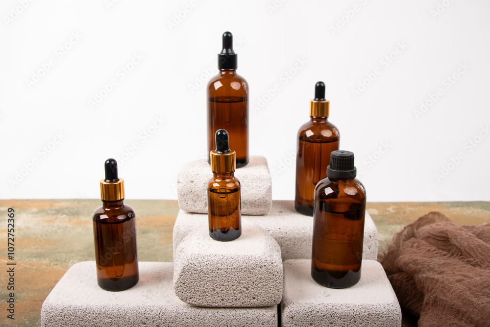 Amber Glass Bottles with Dropper and Screw Caps Displayed on Concrete Blocks Amber Glass Bottles with Dropper and Screw Caps Displayed on Concrete Blocks