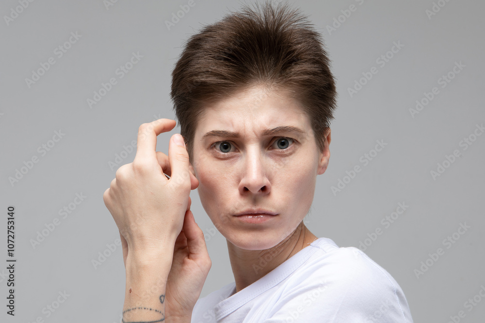 lifestyle, fashion and people concept: young woman model with dark short hair posing in studio. lifestyle, fashion and people concept: young woman model with dark short hair posing in studio.
