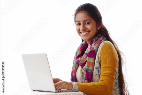 Happy young Indian female college student sitting isolated at white background using laptop computer advertising elearning course, online education webinars, internet services.