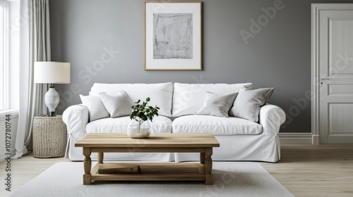 A realistic photo of an airy, bright living room featuring a wooden coffee table near a crisp white sofa. The grey wall with an art poster adds a modern touch. Styled like a high-end lifestyle