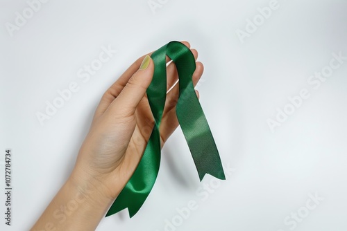 Hand Holding Green Awareness Ribbon photo