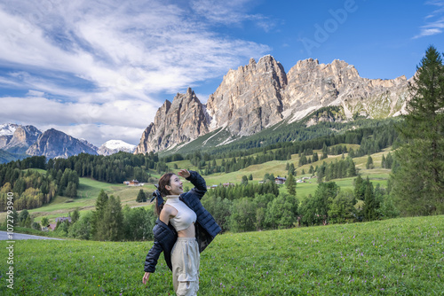 Woman enjoy view of Cortina D Ampezzo mountains landscape Dolomites, Italy. photo