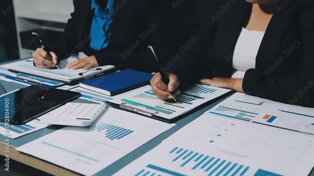 Teamwork with businessman analyzing cost graphs on table at conference room. Teamwork with businessman analyzing cost graphs on table at conference room.