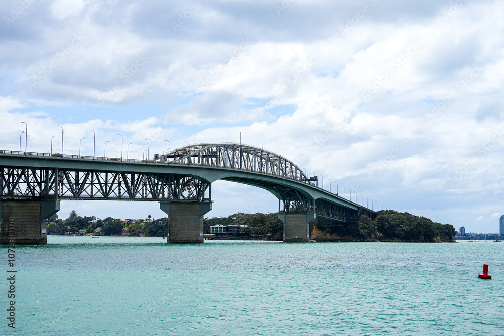 Majestic View of the Iconic Suspension Bridge Spanning the Clear Blue Waters under a Dramatic Cloudy Sky, Perfect for Travel and Infrastructure Themes Majestic View of the Iconic Suspension Bridge Spanning the Clear Blue Waters under a Dramatic Cloudy Sky, Perfect for Travel and Infrastructure Themes