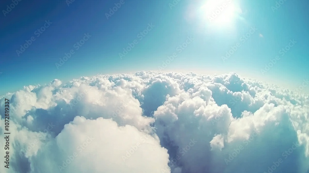 High-altitude view of clouds from above, with a bright blue sky creating a sense of freedom and space. High-altitude view of clouds from above, with a bright blue sky creating a sense of freedom and space.