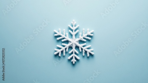 A single snowflake icon centered on a solid light blue background, minimalist design