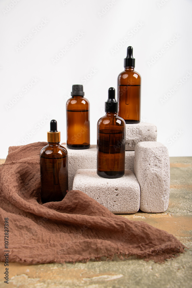 Amber Glass Bottles with Dropper and Screw Caps Displayed on Concrete Blocks Amber Glass Bottles with Dropper and Screw Caps Displayed on Concrete Blocks