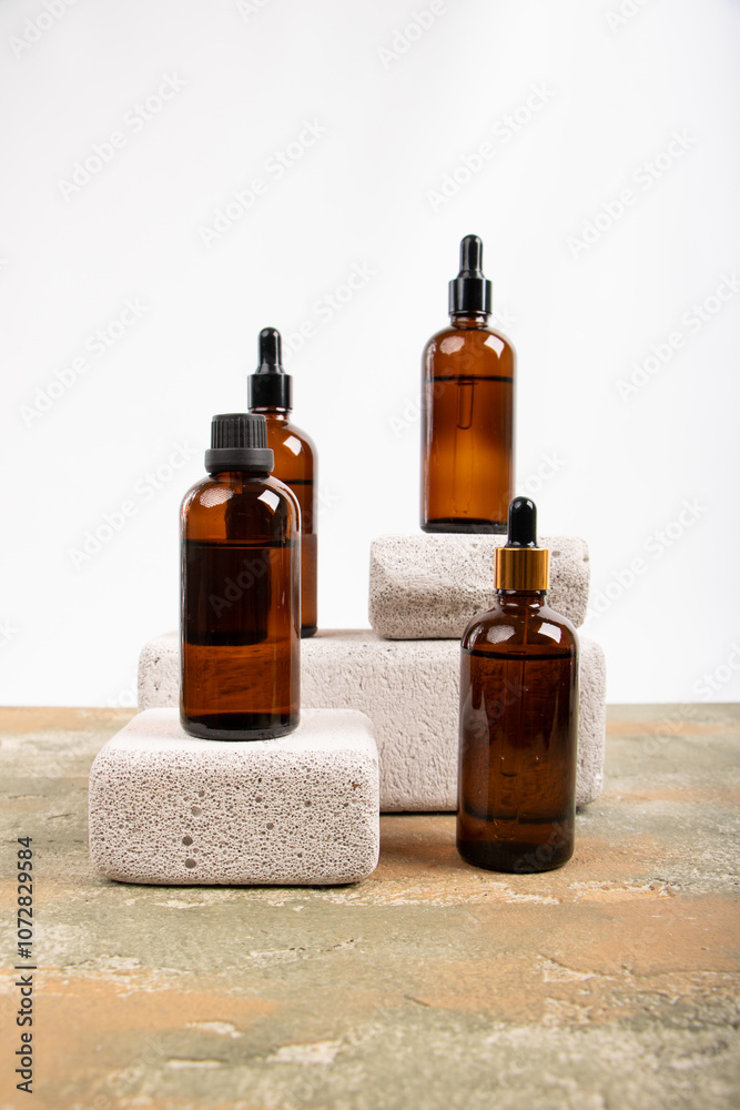 Amber Glass Bottles with Dropper and Screw Caps Displayed on Concrete Blocks Amber Glass Bottles with Dropper and Screw Caps Displayed on Concrete Blocks