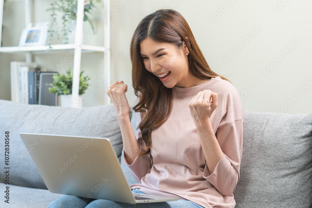 Happy cheerful asian young woman celebrating lottery win or achievement, looking at laptop computer screen, received good news, enjoy with offer discount for shopping online, making surprise gesture Happy cheerful asian young woman celebrating lottery win or achievement, looking at laptop computer screen, received good news, enjoy with offer discount for shopping online, making surprise gesture