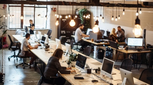 Modern open plan office with employees working at desks.