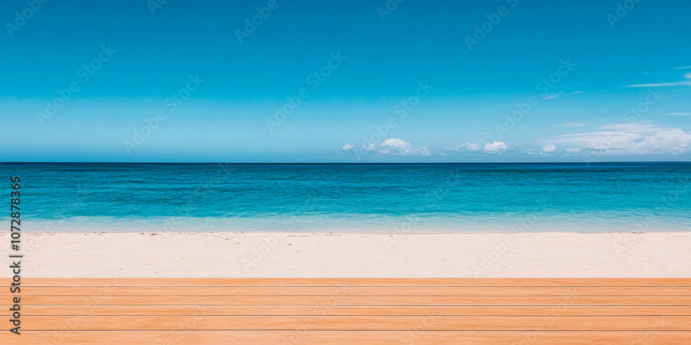 Fototapeta premium Serene sandy beach with crystal clear waters and wooden decking under a bright blue sky