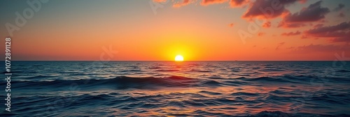 A warm orange glow spreads across the water as the sun rises above the ocean, rocky shoreline, fog roll photo