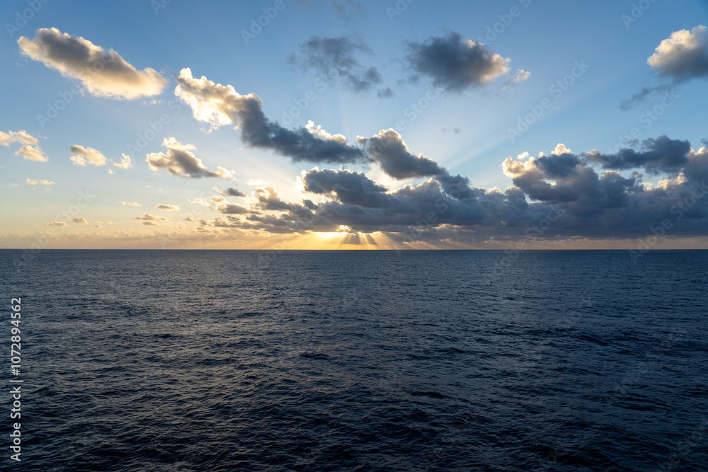 Fototapeta premium Stunning sunset over the ocean viewed from a cruise ship in the Atlantic